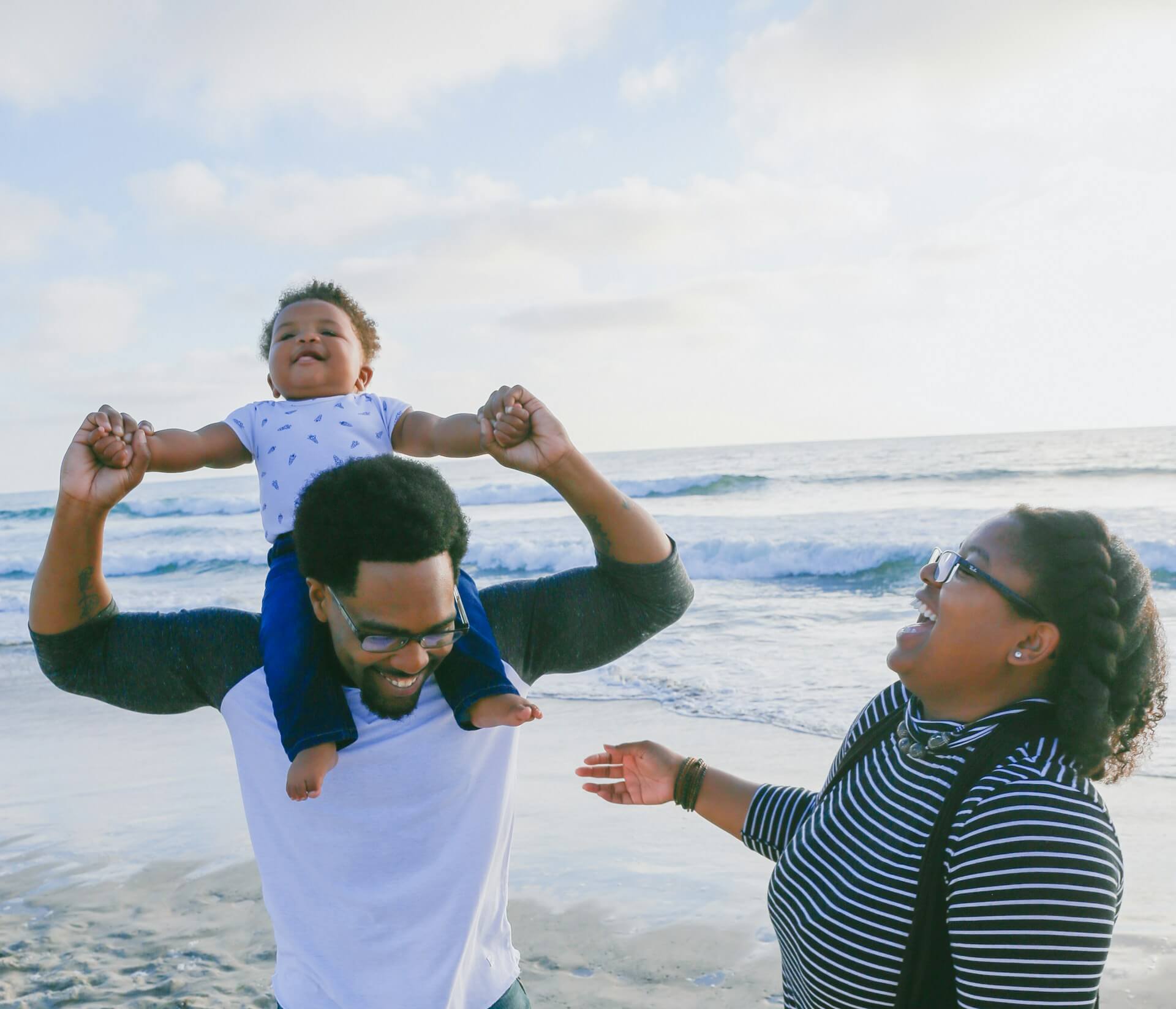 family with kid at beach